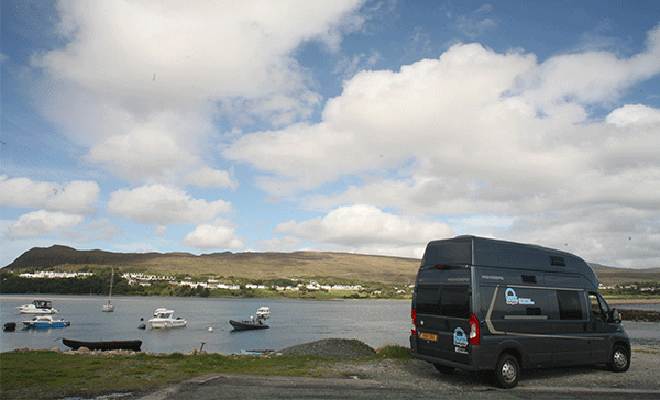 Touring a harbour in a bunk campervan hire 