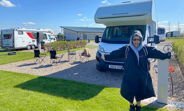 A woman embracing the great outdoors on her motorhome holiday