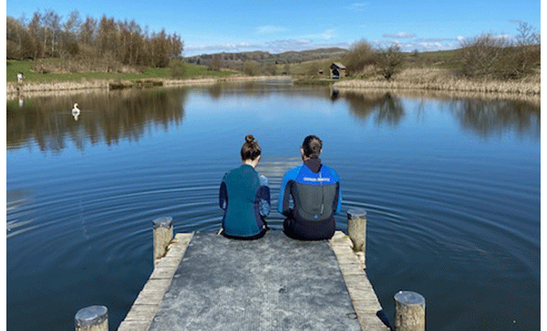 Swimmers taking in the view from a lake in Wales