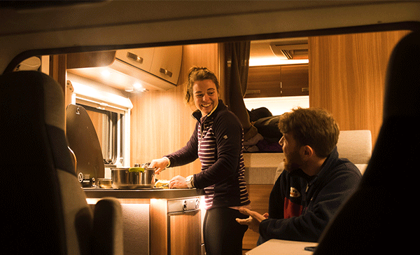 A family cooking in a campervan